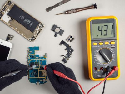 component-reclamation-technician-testing-board-multimeter